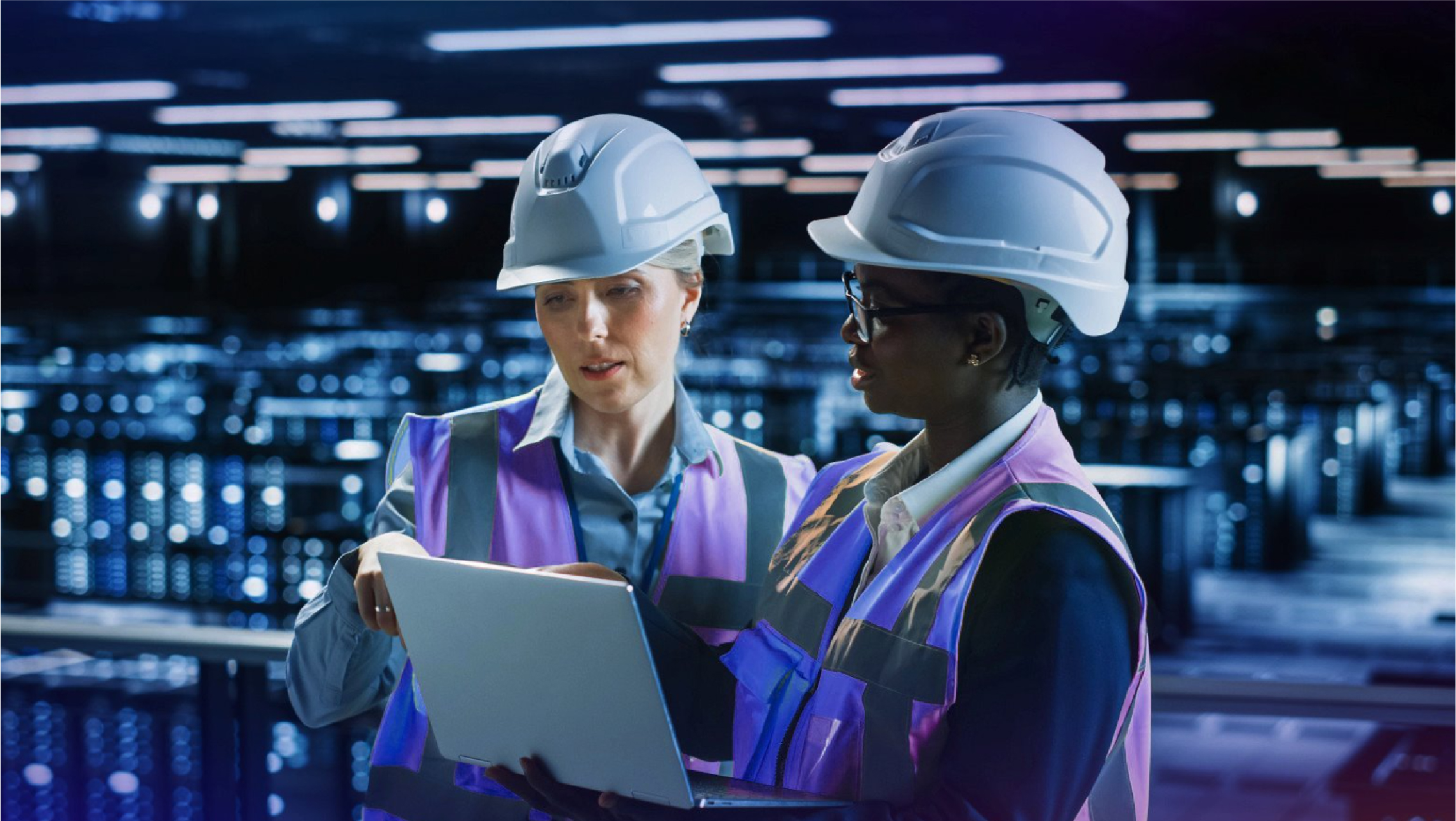 Engineers looking at laptop in Data Center