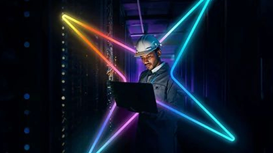 Individual looking at a computer in a data center with the Ecolab spark surrounding him